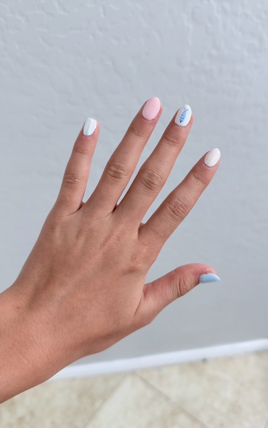Milky blush chrome manicure with pastel accents by Raegan