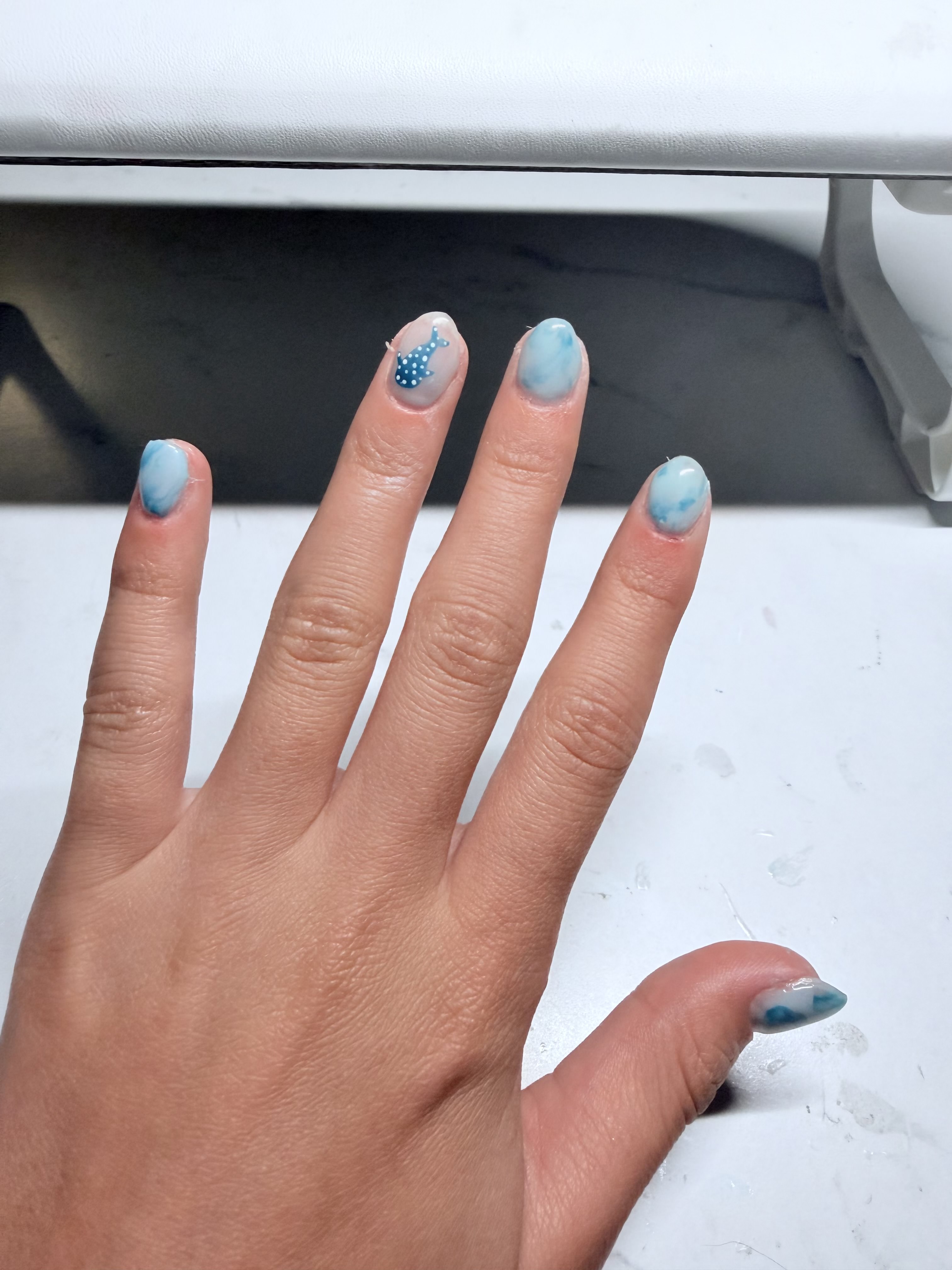 Soft blue floral and ocean-inspired gel nail art by Raegan